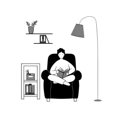 A woman sitting on a comfortable chair and reading a book