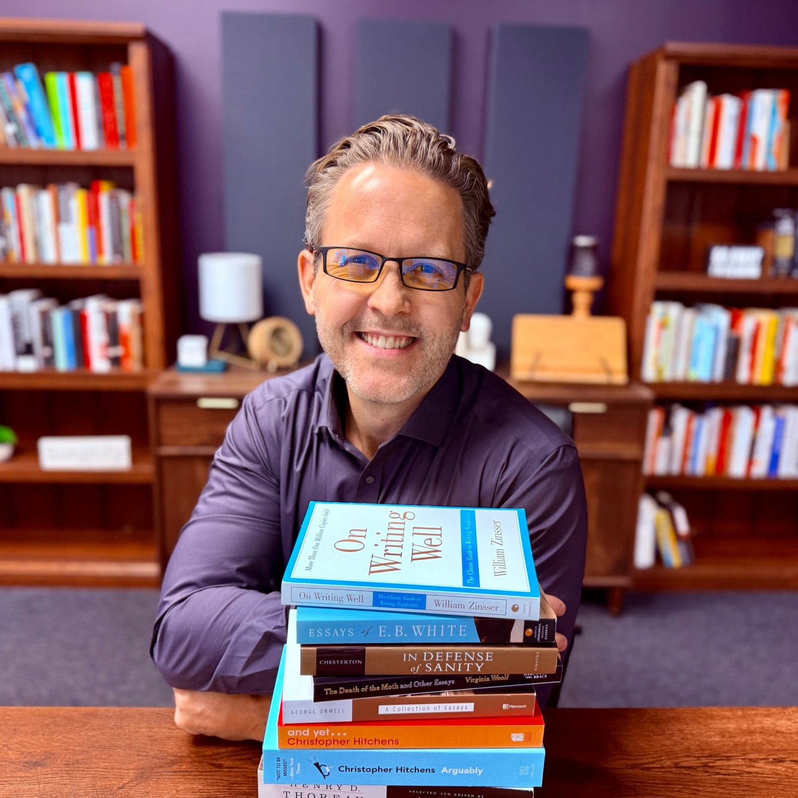 Eddy Hood with a stack of books