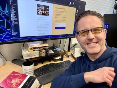 Eddy Hood at his desk writing a newsletter