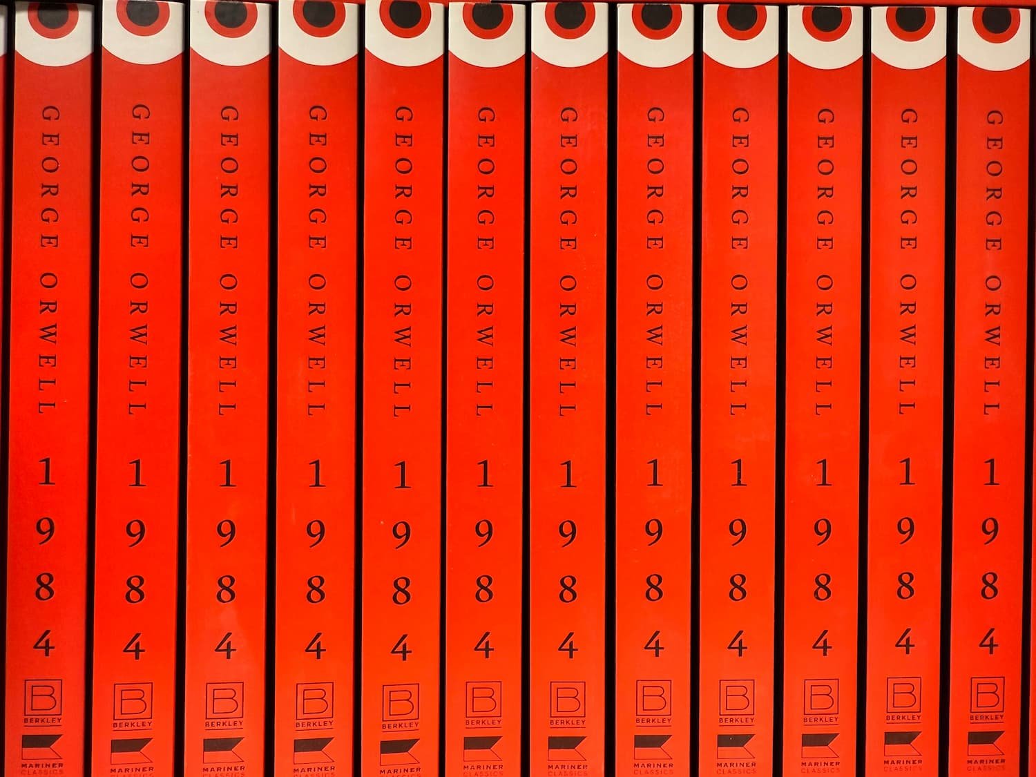 A row of books by George Orwell titled 1984
